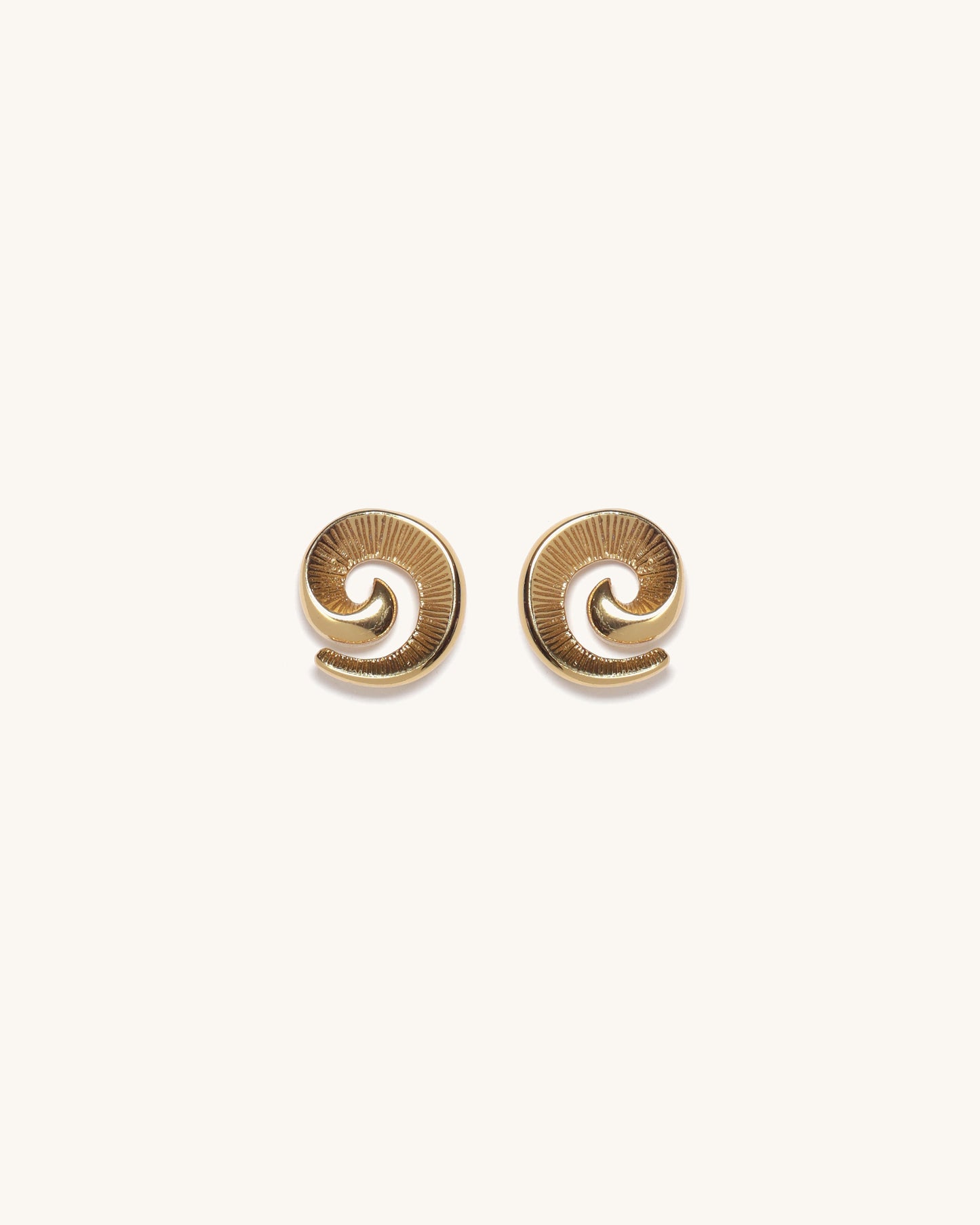Pair of gold spiral earrings on a white background