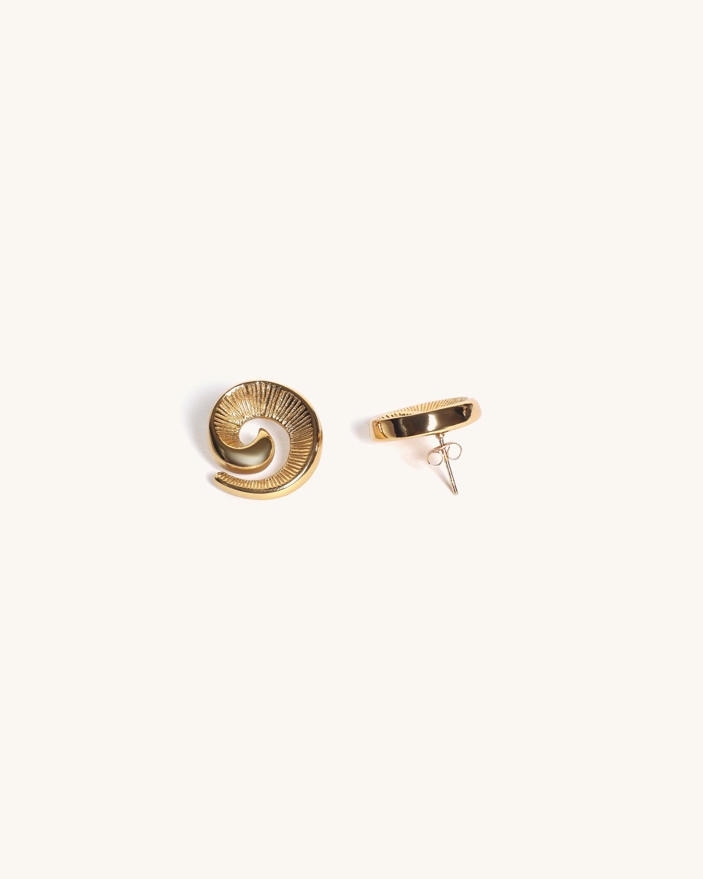 Gold spiral earrings on a white background