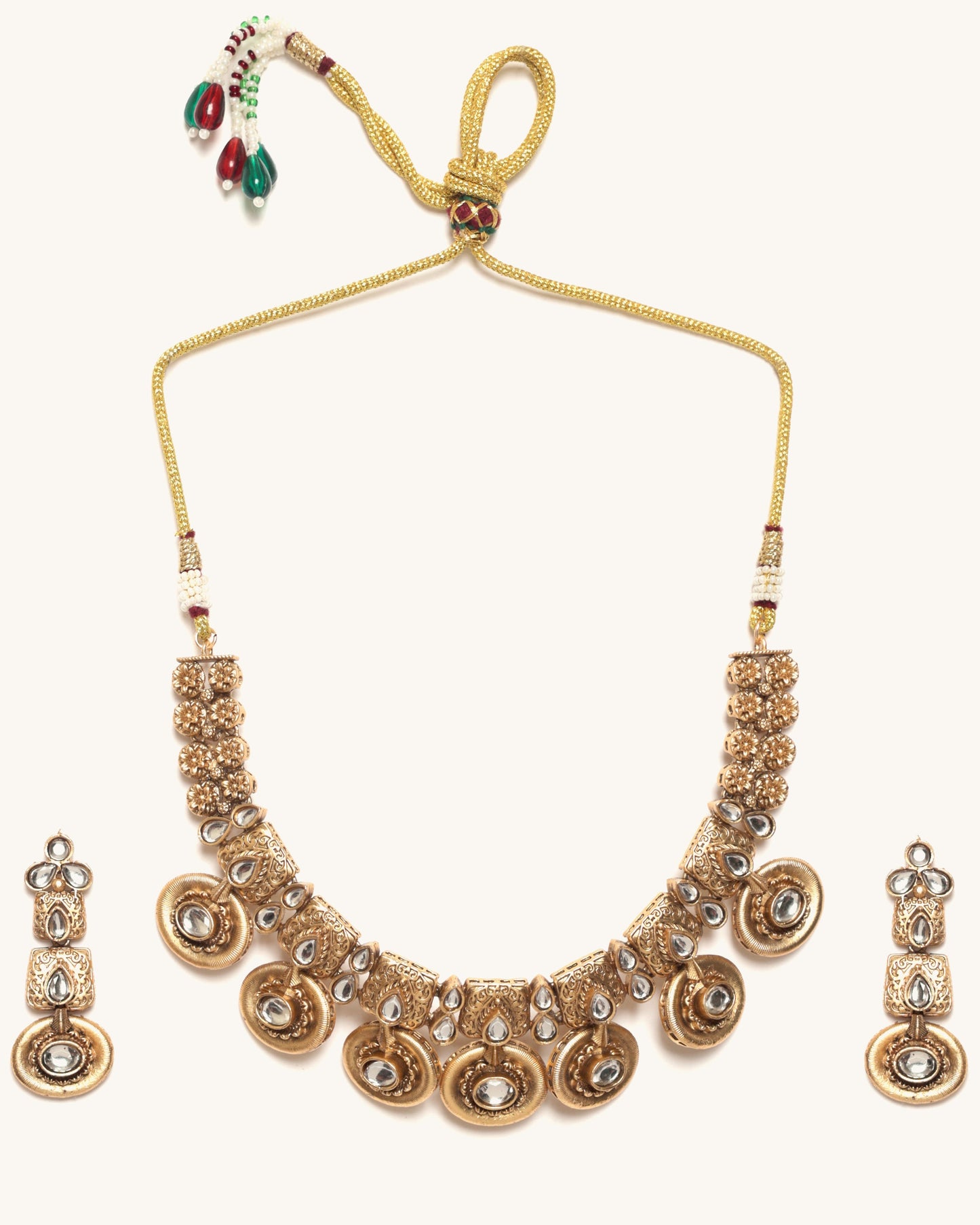 Gold necklace set with matching earrings on a white background