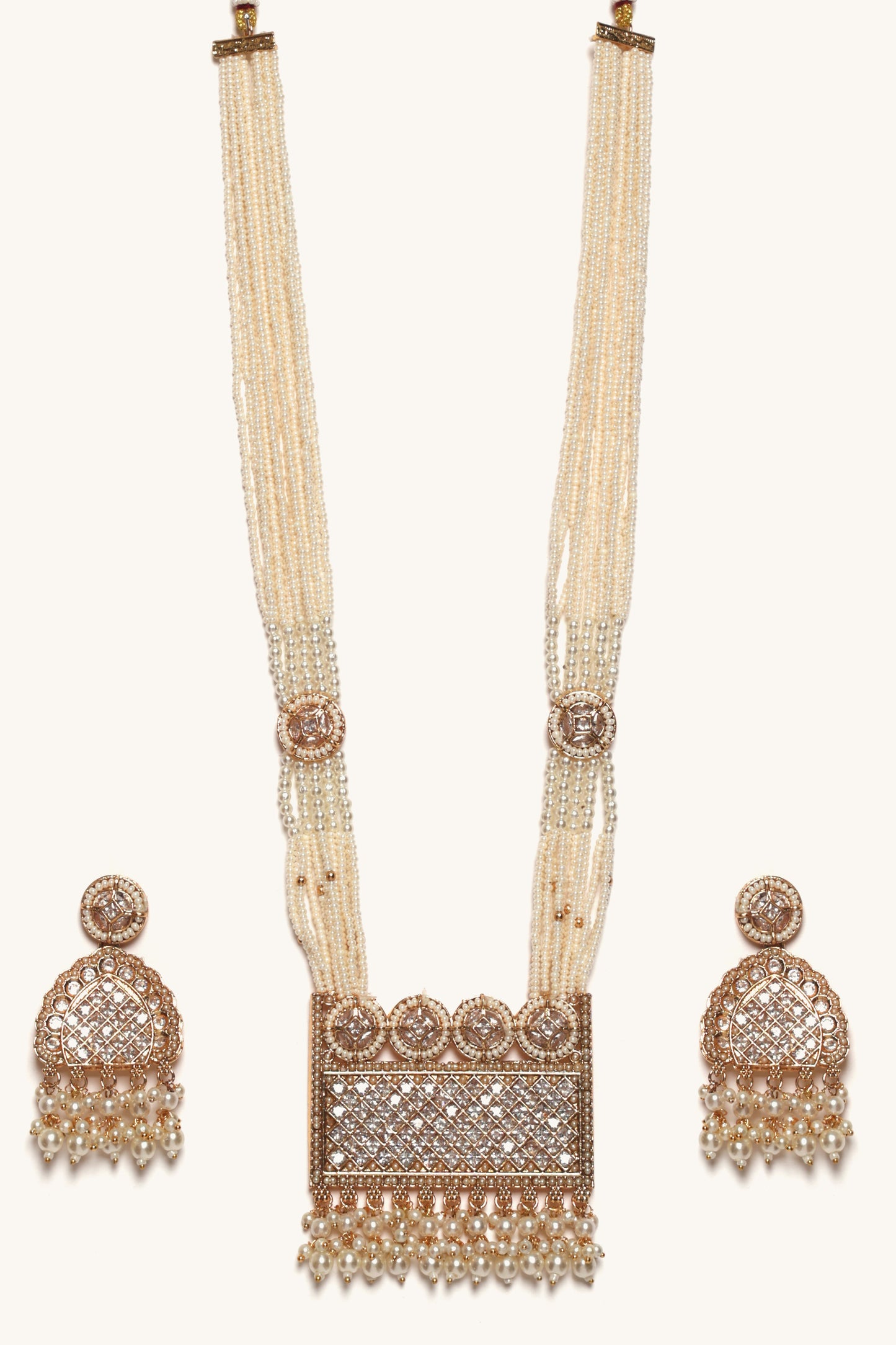 Beige necklace with matching earrings on a white background