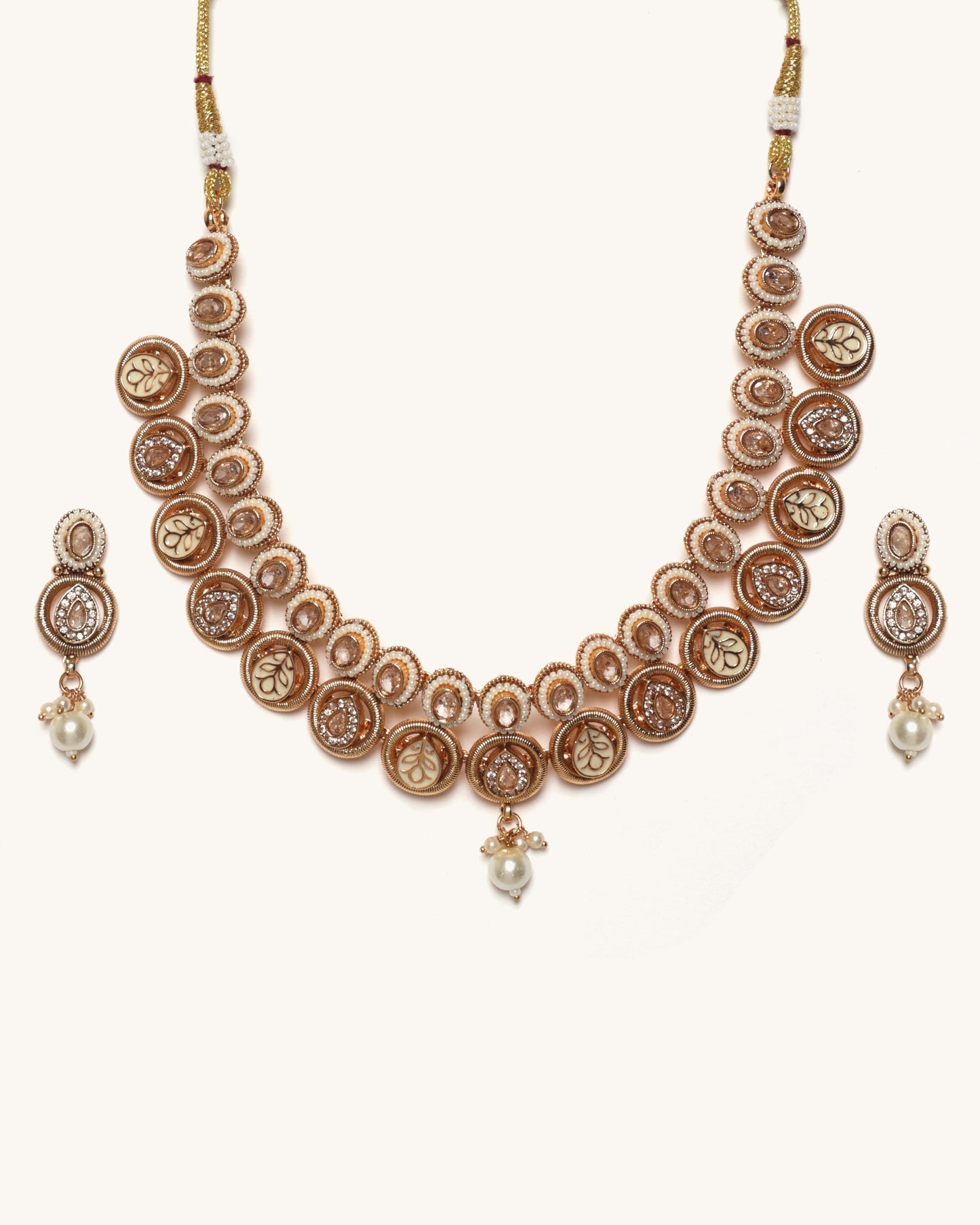 Rose gold necklace with matching earrings on a white background