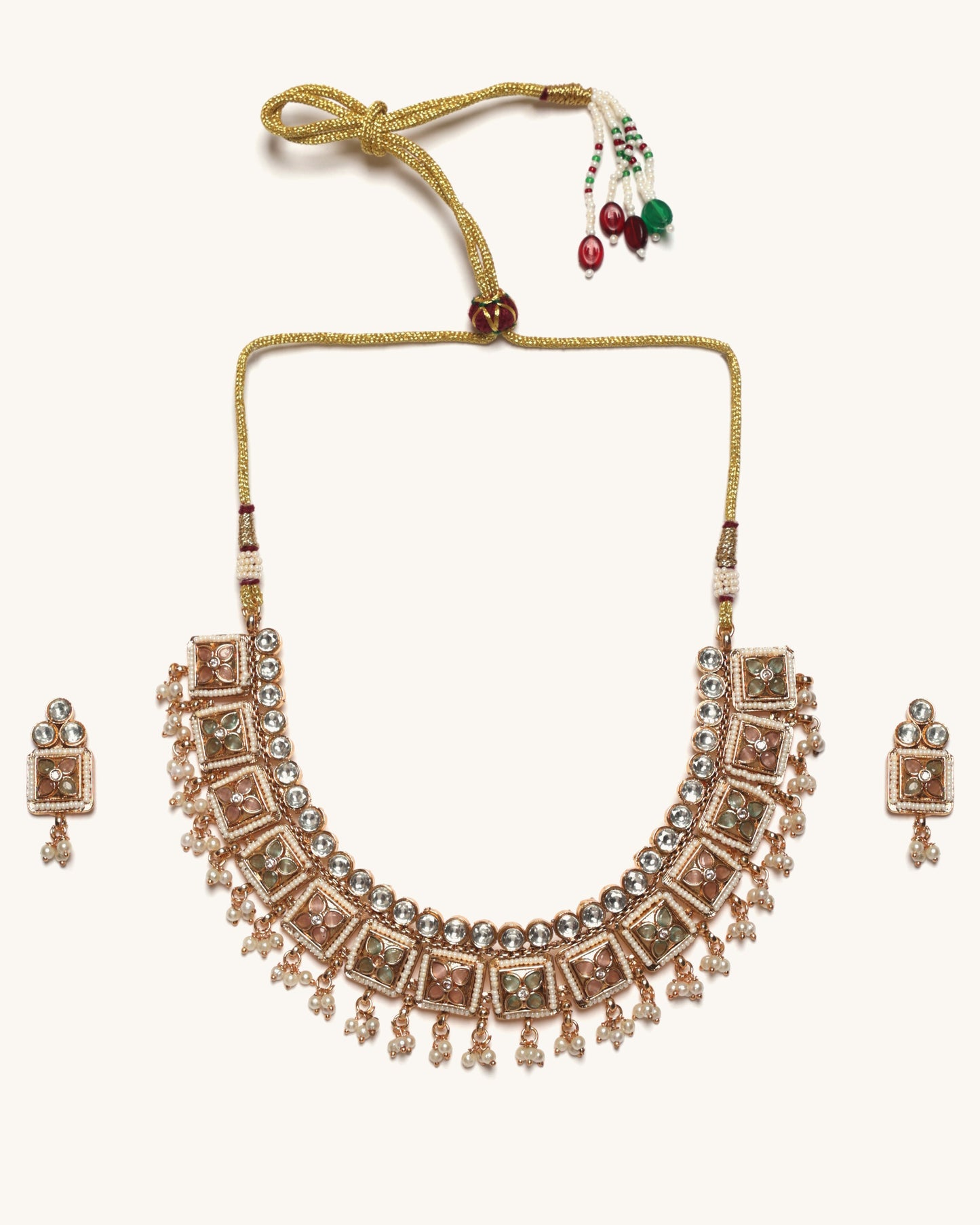 Rose gold necklace with matching earrings on a white background