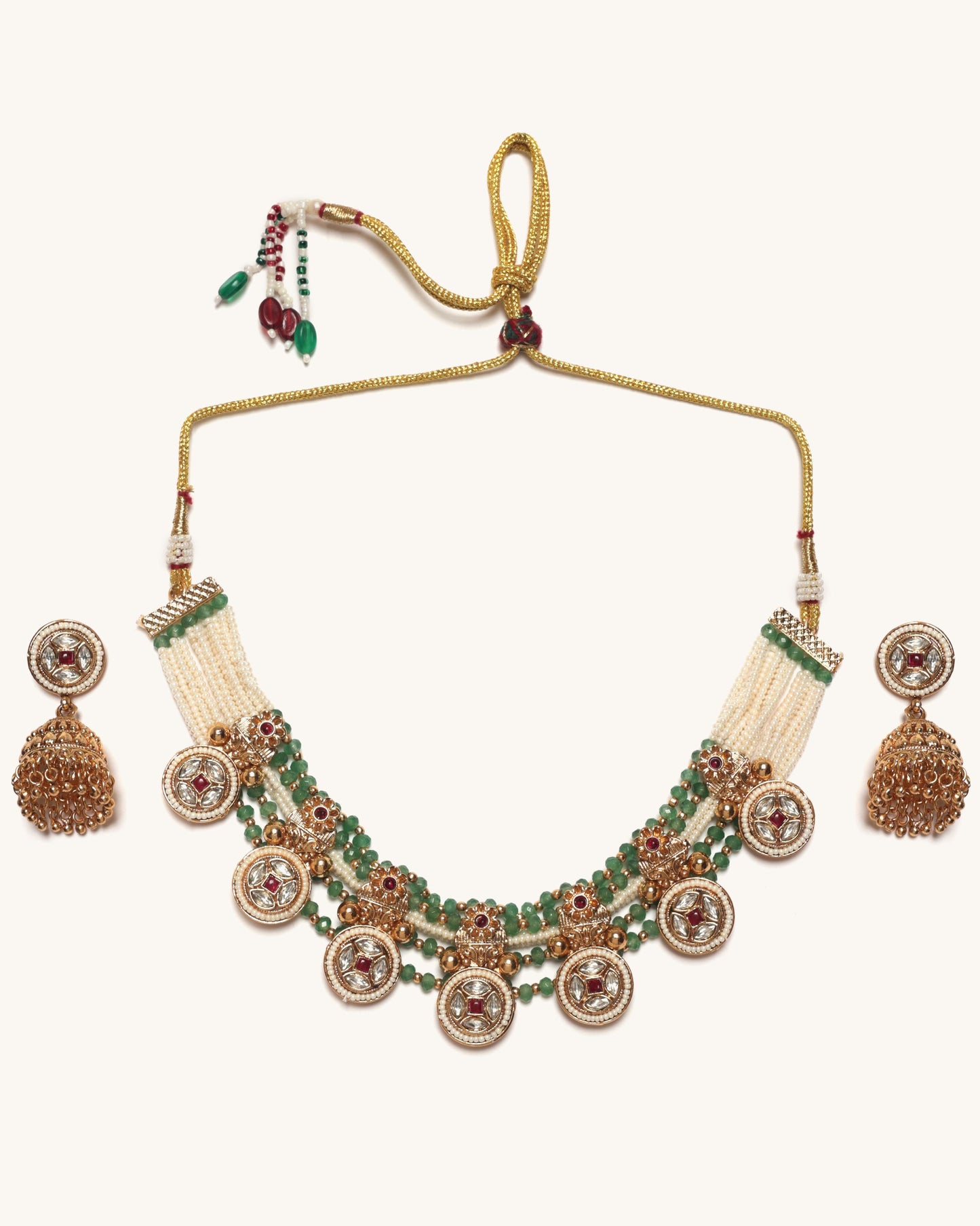 Ornate necklace with green stones and gold accents on a white background