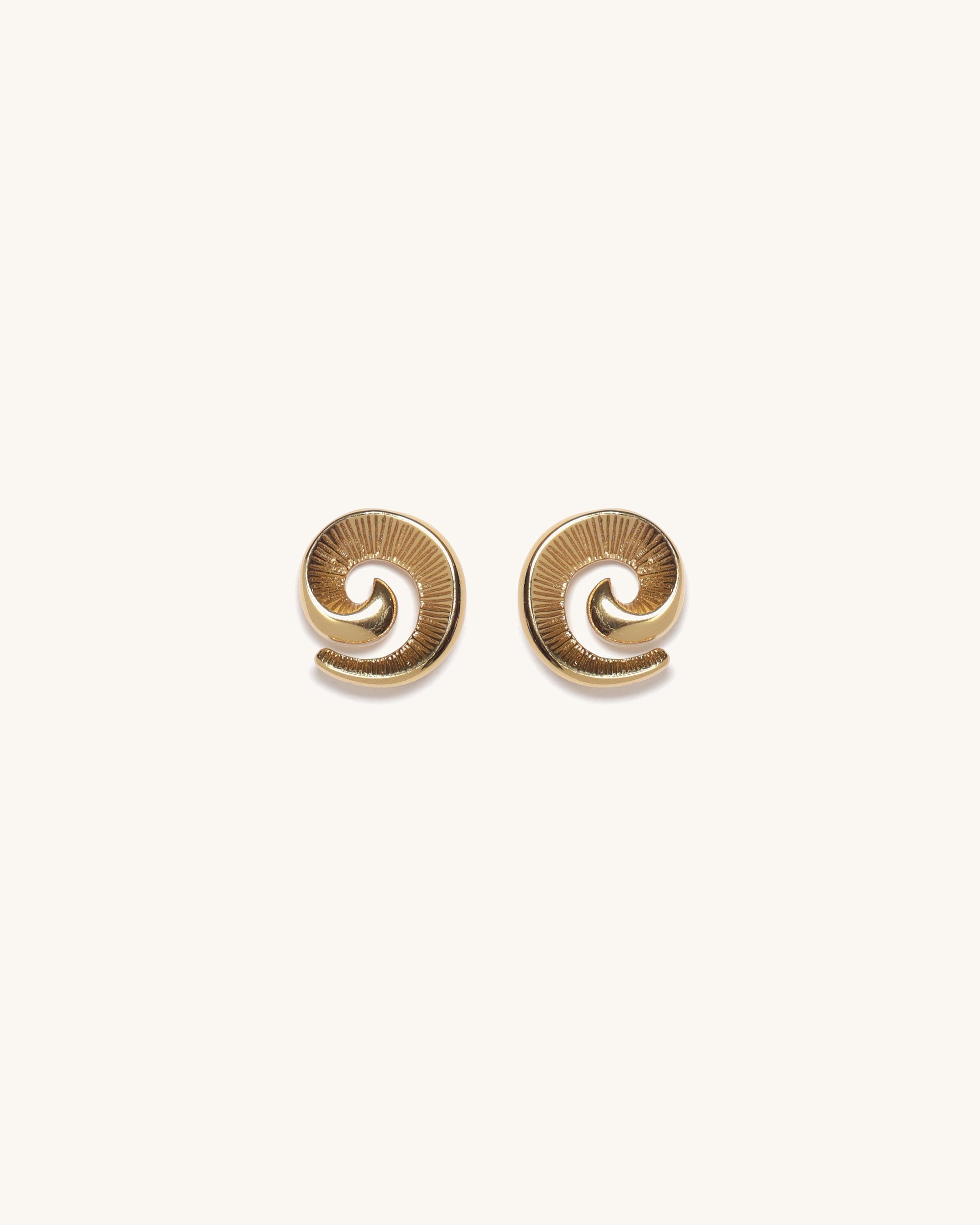 Pair of gold spiral earrings on a white background