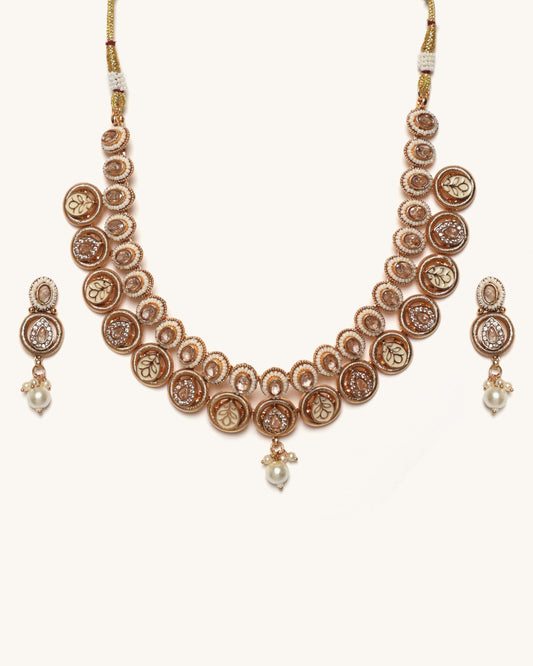 Rose gold necklace with matching earrings on a white background