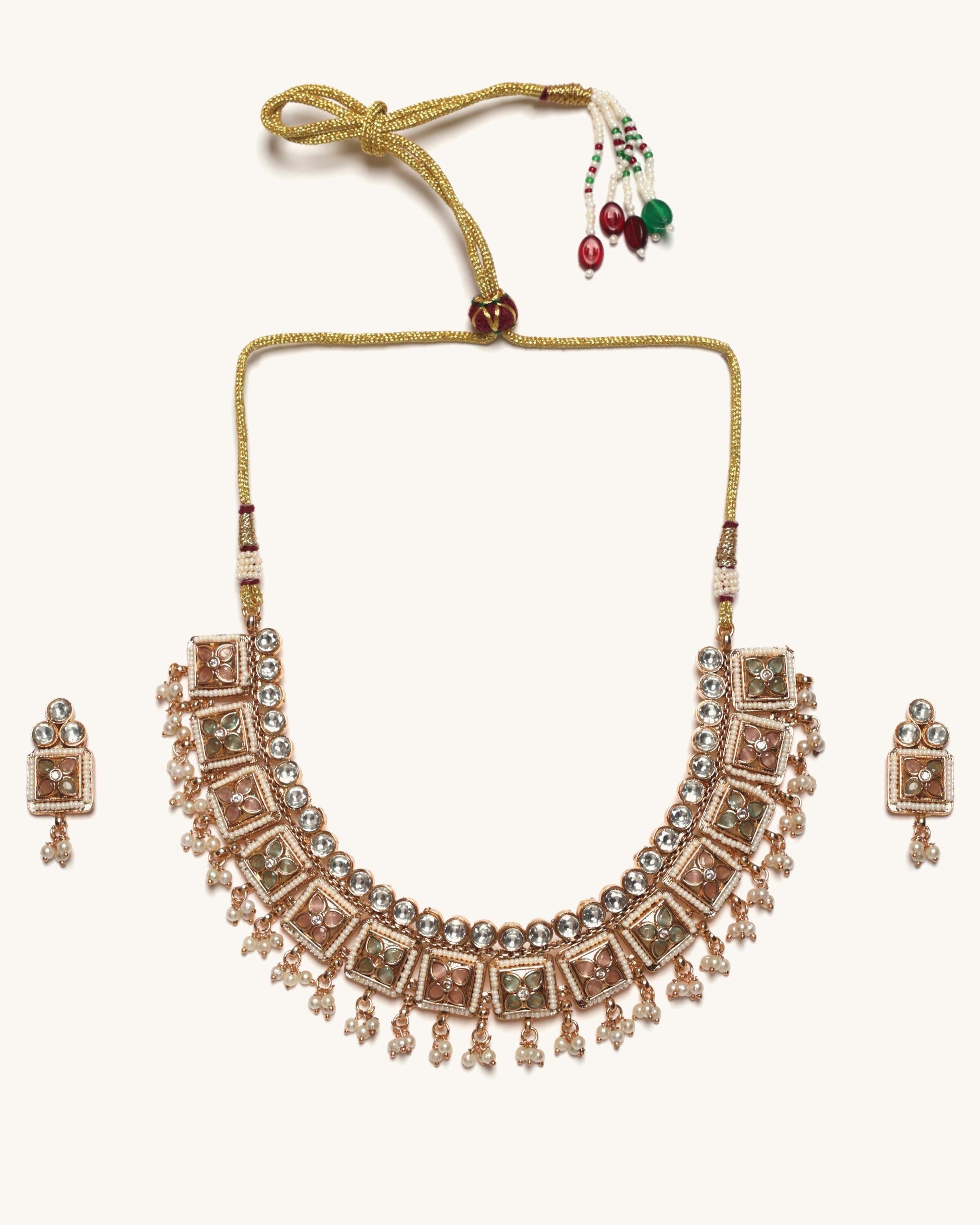 Rose gold necklace with matching earrings on a white background