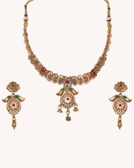Ornate necklace with matching earrings on a white background