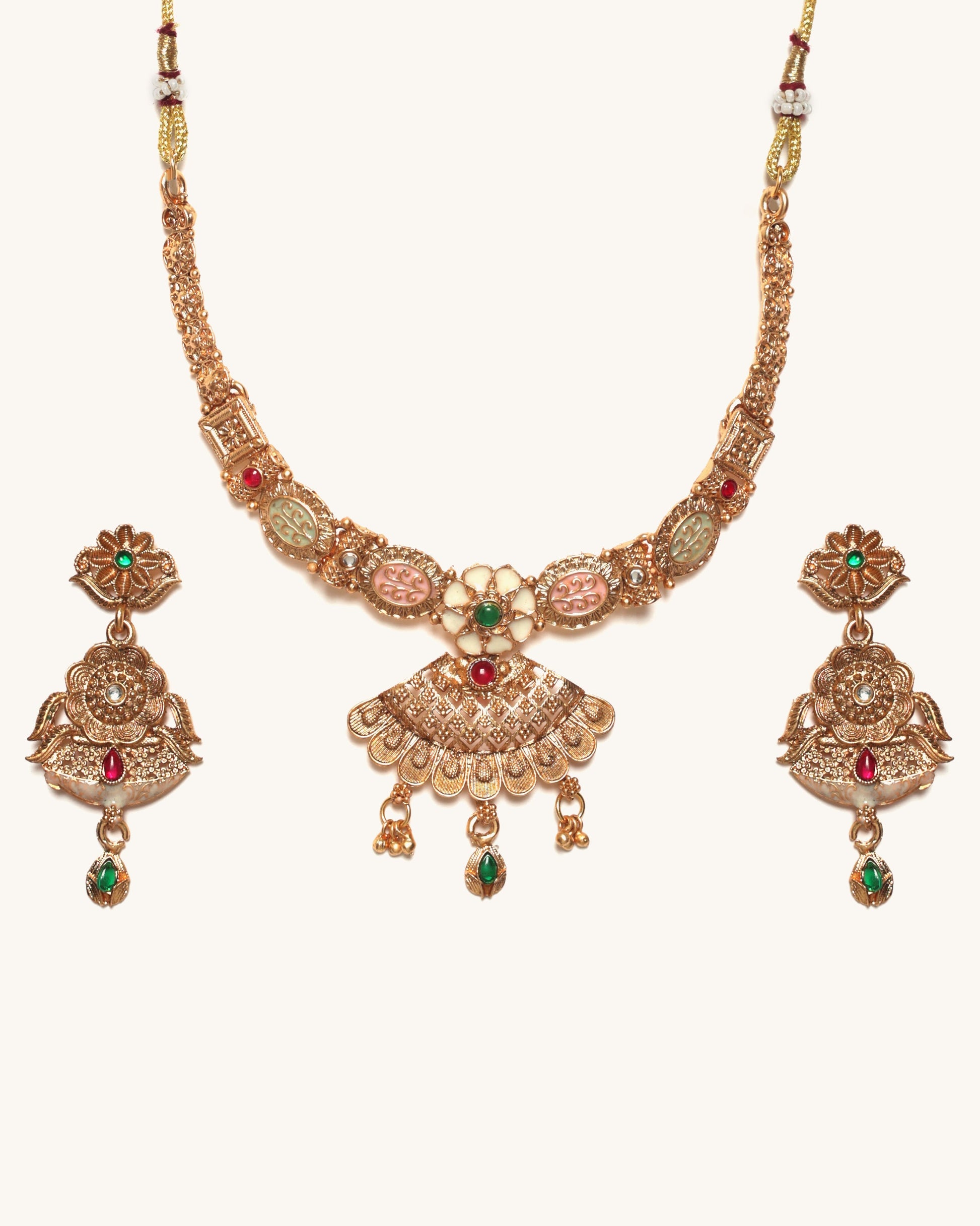 Gold necklace set with earrings on a white background