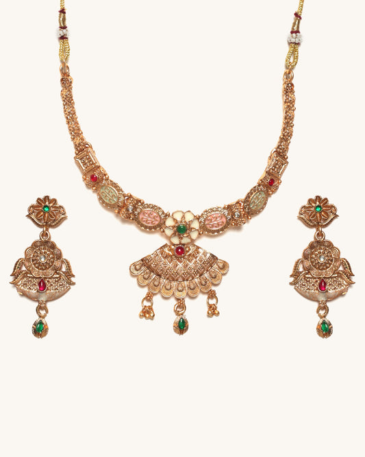 Gold necklace set with earrings on a white background